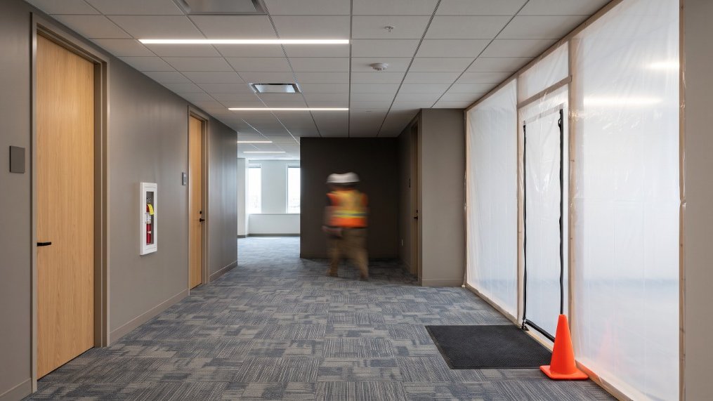 Contained work zone on an occupied floor with protective barriers.